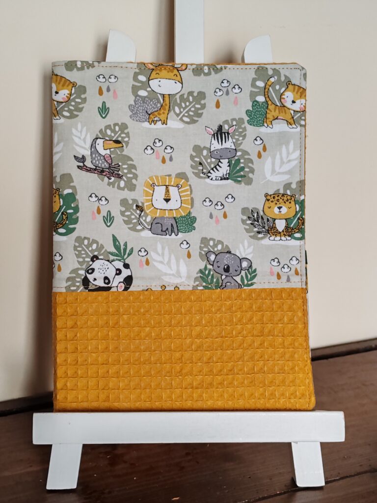 Couverture d'un carnet de santé confectionné par la créatrice de Coudre et Broder. Réalisé en tissu