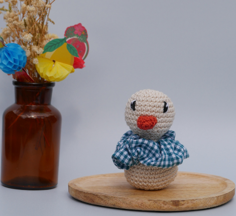 Petit canard en crochet fait main avec collerette à carreaux bleus, création doudou pour enfant Bleu Perrine.